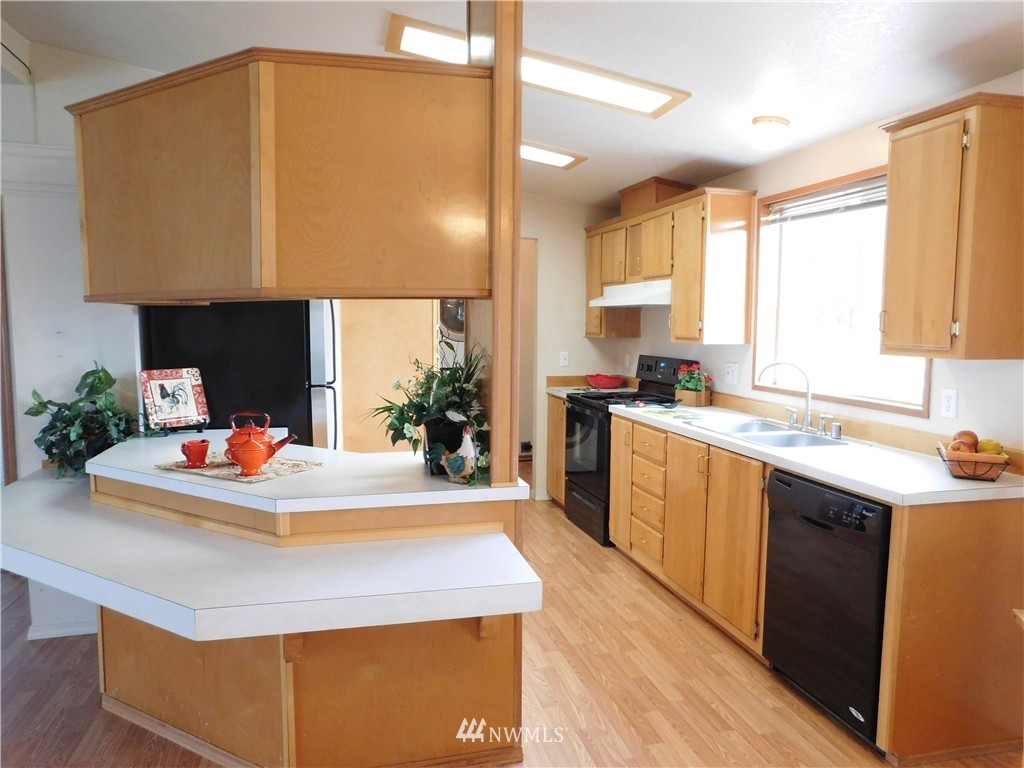 18022 Lawton Lane Southwest Rochester, WA 98579 - Photo 13 of 25 a kitchen with kitchen island a sink a stove and a window