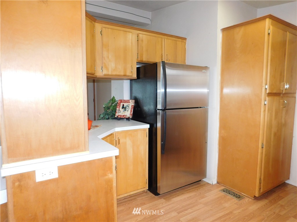 18022 Lawton Lane Southwest Rochester, WA 98579 - Photo 14 of 25 a kitchen with a refrigerator and a more window