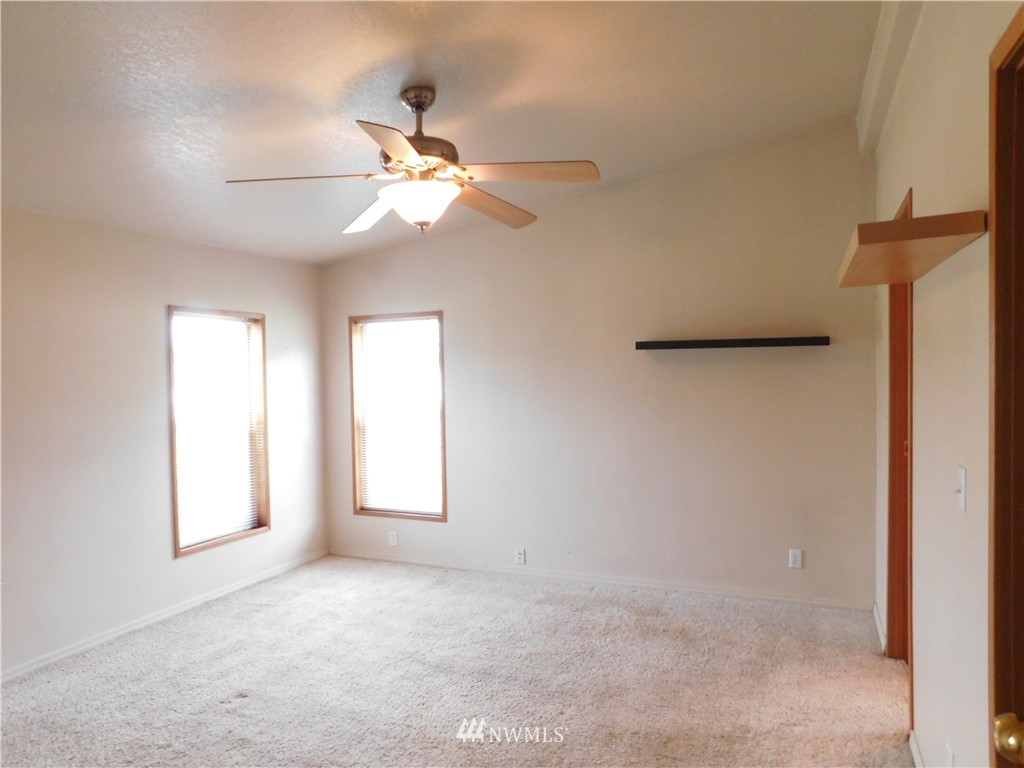 18022 Lawton Lane Southwest Rochester, WA 98579 - Photo 17 of 25 an empty room with windows and fan