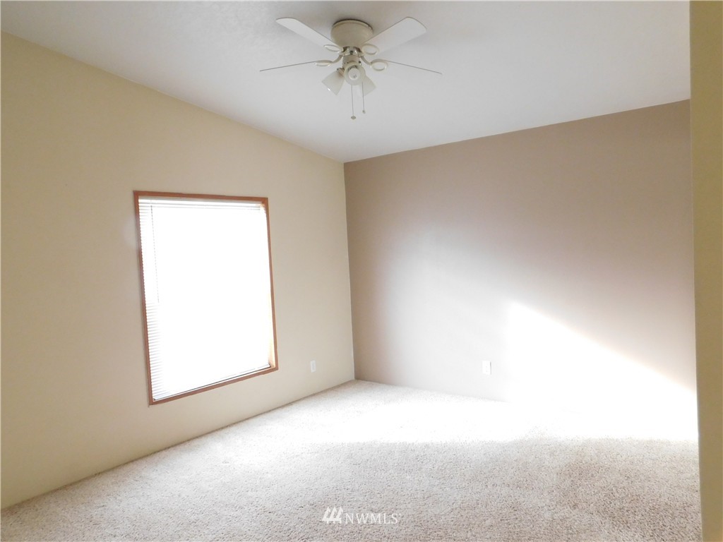 18022 Lawton Lane Southwest Rochester, WA 98579 - Photo 22 of 25 an empty room with windows and fan