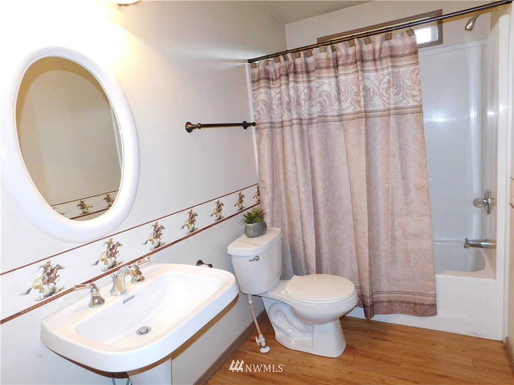 18022 Lawton Lane Southwest Rochester, WA 98579 - Photo 24 of 25 a bathroom with a sink a toilet and a mirror