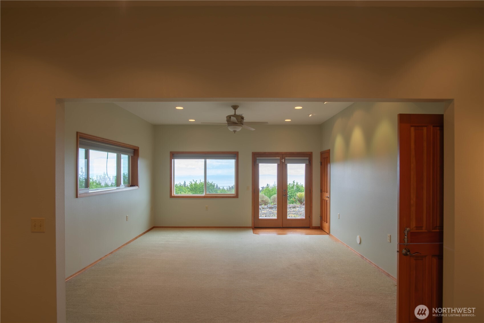 975 Simmons Road Port Angeles, WA 98362 - Photo 33 of 40 an empty room with windows and chandelier