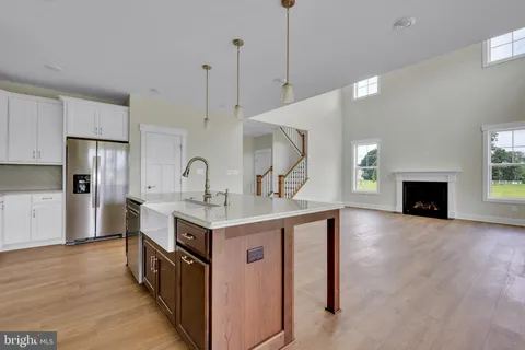 a kitchen with kitchen island a sink appliances and cabinets