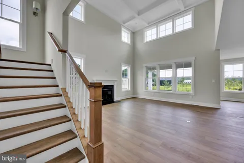 a view of an entryway with wooden floor and balcony