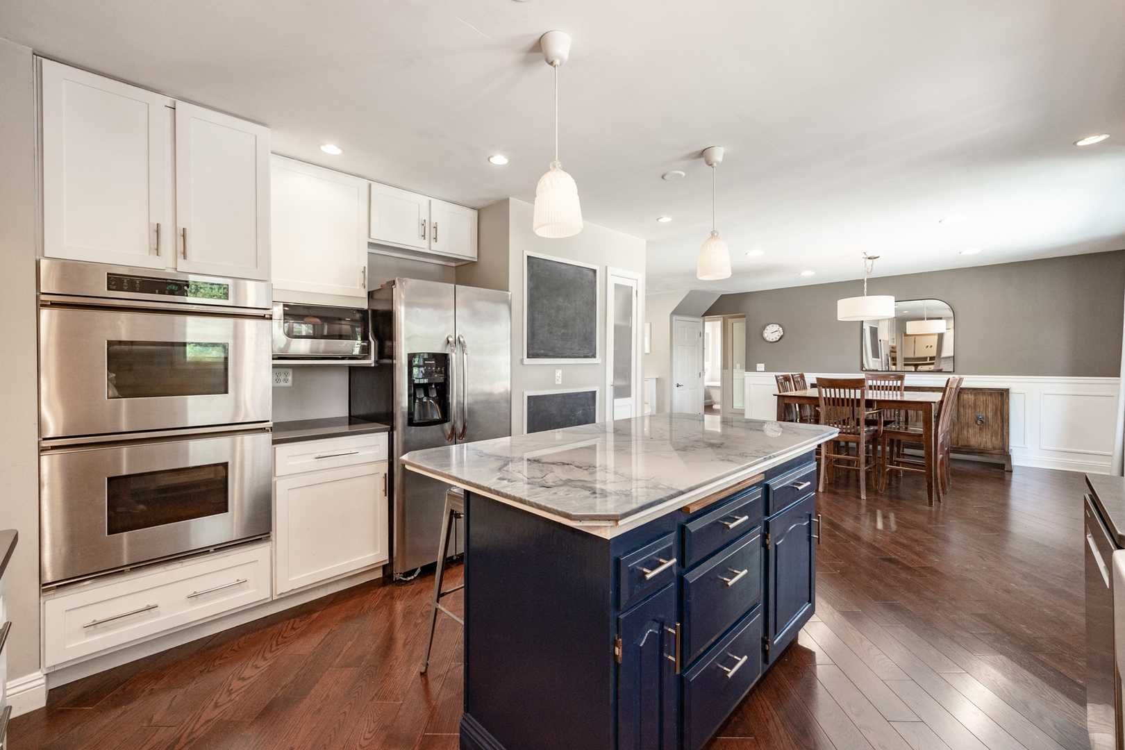 1223 Ridgeway Drive Elgin, IL 60123 - Photo 15 of 40 a kitchen with a stove a refrigerator and a dining table with wooden floor