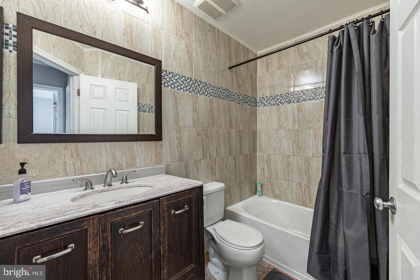 1021 3rd Place Southeast Washington, DC 20003 - Photo 19 of 29 a bathroom with a granite countertop sink toilet and shower