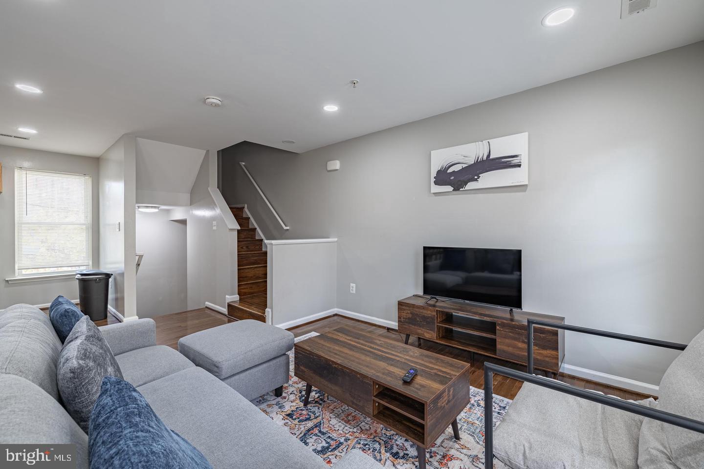 1021 3rd Place Southeast Washington, DC 20003 - Photo 10 of 29 a living room with furniture and a flat screen tv