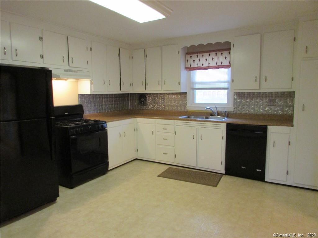 235 Shaker Road Enfield, CT 06082 - Photo 5 of 15 a kitchen with a sink and cabinets