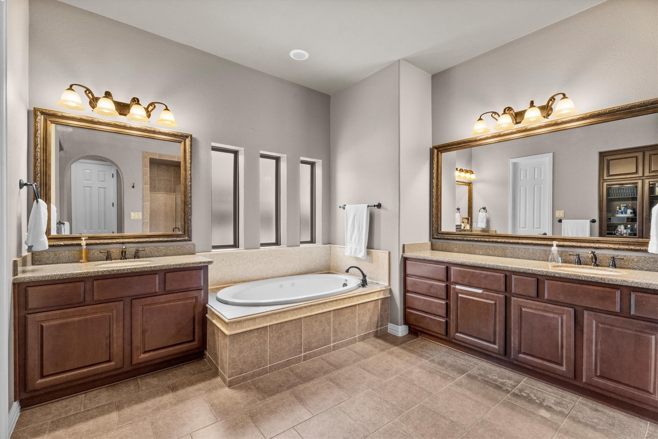 130 East Cove View Trail Spring, TX 77389 - Photo 23 of 50 Primary bathroom features his and hers vanities as well as very spacious his and hers closets.