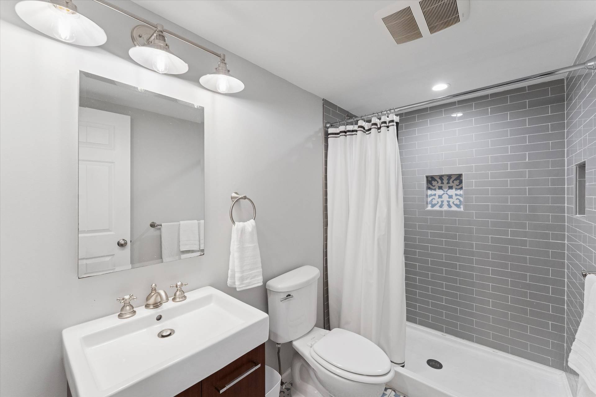 19 Maple Street Westhampton Beach, NY 11978 - Photo 17 of 23 a bathroom with a sink a toilet and shower