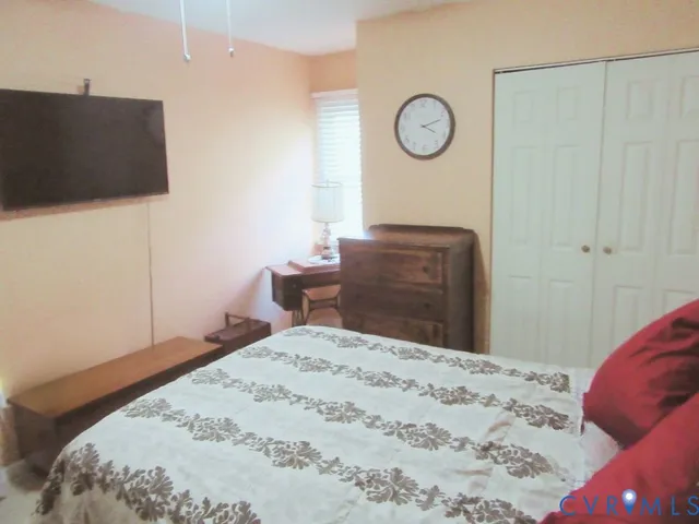 a bedroom with a bed and a dresser