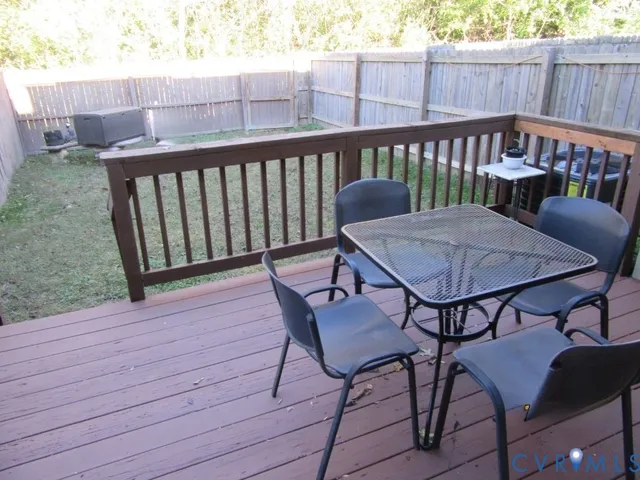 a view of a wooden bench on the roof deck