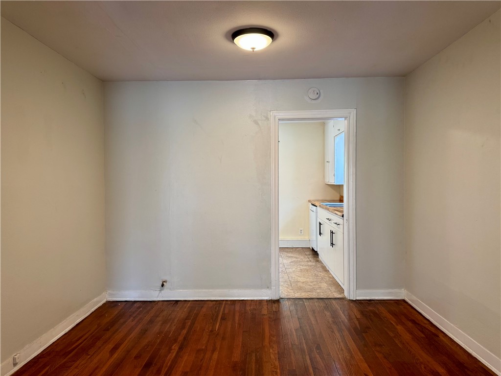 2805 Austin Street, Unit B Corpus Christi, TX 78404 - Photo 6 of 13 an empty room with wooden floor and windows