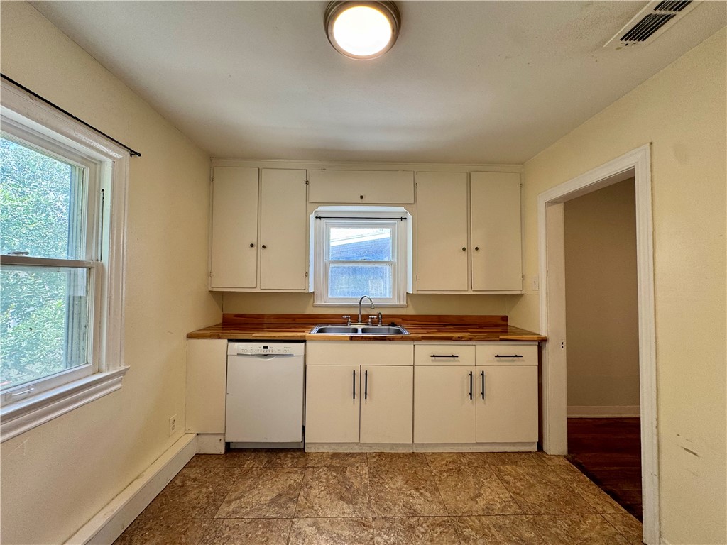 2805 Austin Street, Unit B Corpus Christi, TX 78404 - Photo 7 of 13 a room with stainless steel appliances granite countertop a stove and a sink