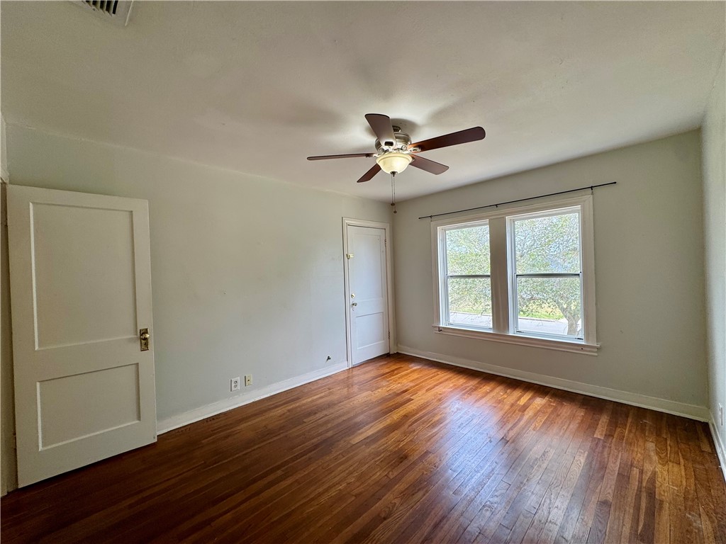 2805 Austin Street, Unit B Corpus Christi, TX 78404 - Photo 10 of 13 a view of an empty room with wooden floor and a window