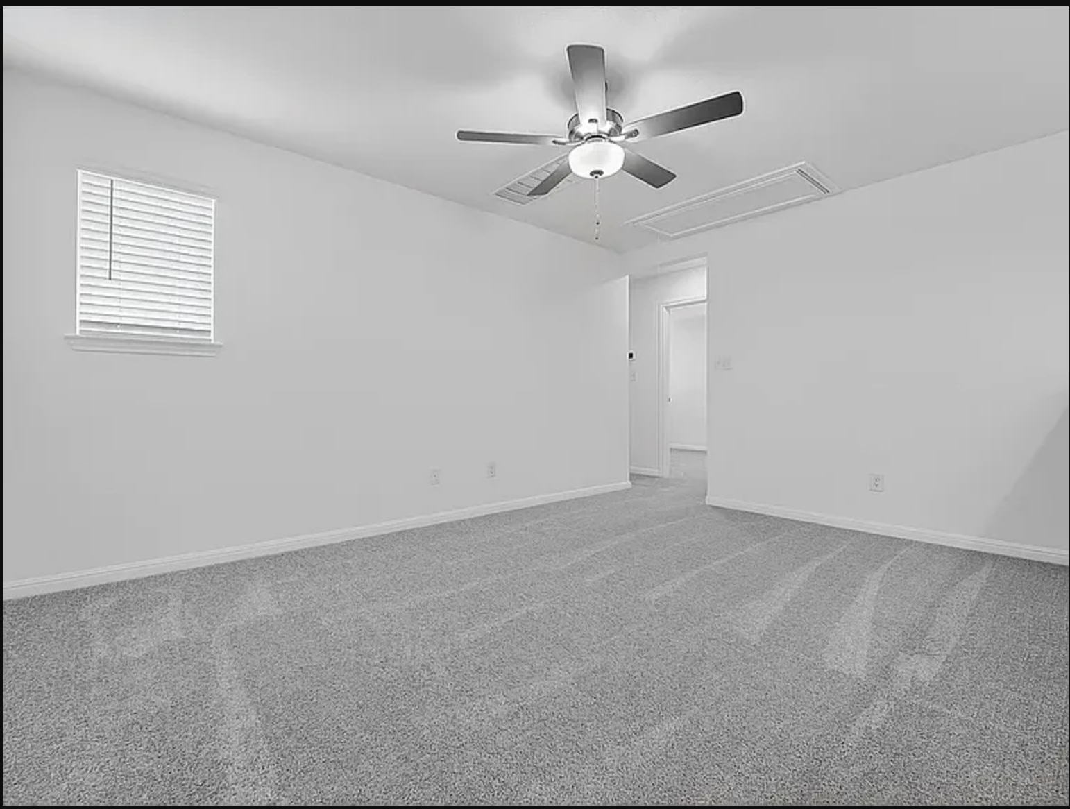 203 Betsy Road Hutto, TX 78634 - Photo 8 of 21 Plush carpeting anchors this versatile room boasting clean walls and a classic window.
