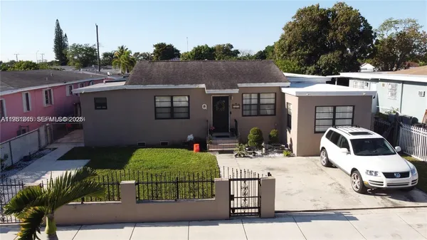 a view of a house with backyard and sitting area