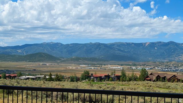 7885 North Rabbitbrush Court, Unit 13 Park City, UT 84098 - Photo 4 of 88 Expansive mountain landscape with distant valleys and scattered residential properties under a partially cloudy sky