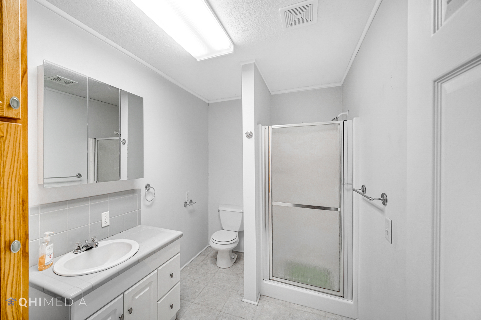 2263 Fox Run Drive Kankakee, IL 60901 - Photo 25 of 34 a bathroom with a shower sink vanity mirror and toilet