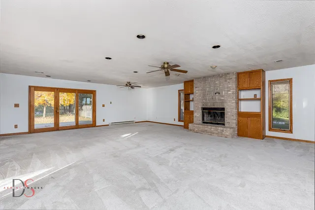 an empty room with furniture and a fireplace