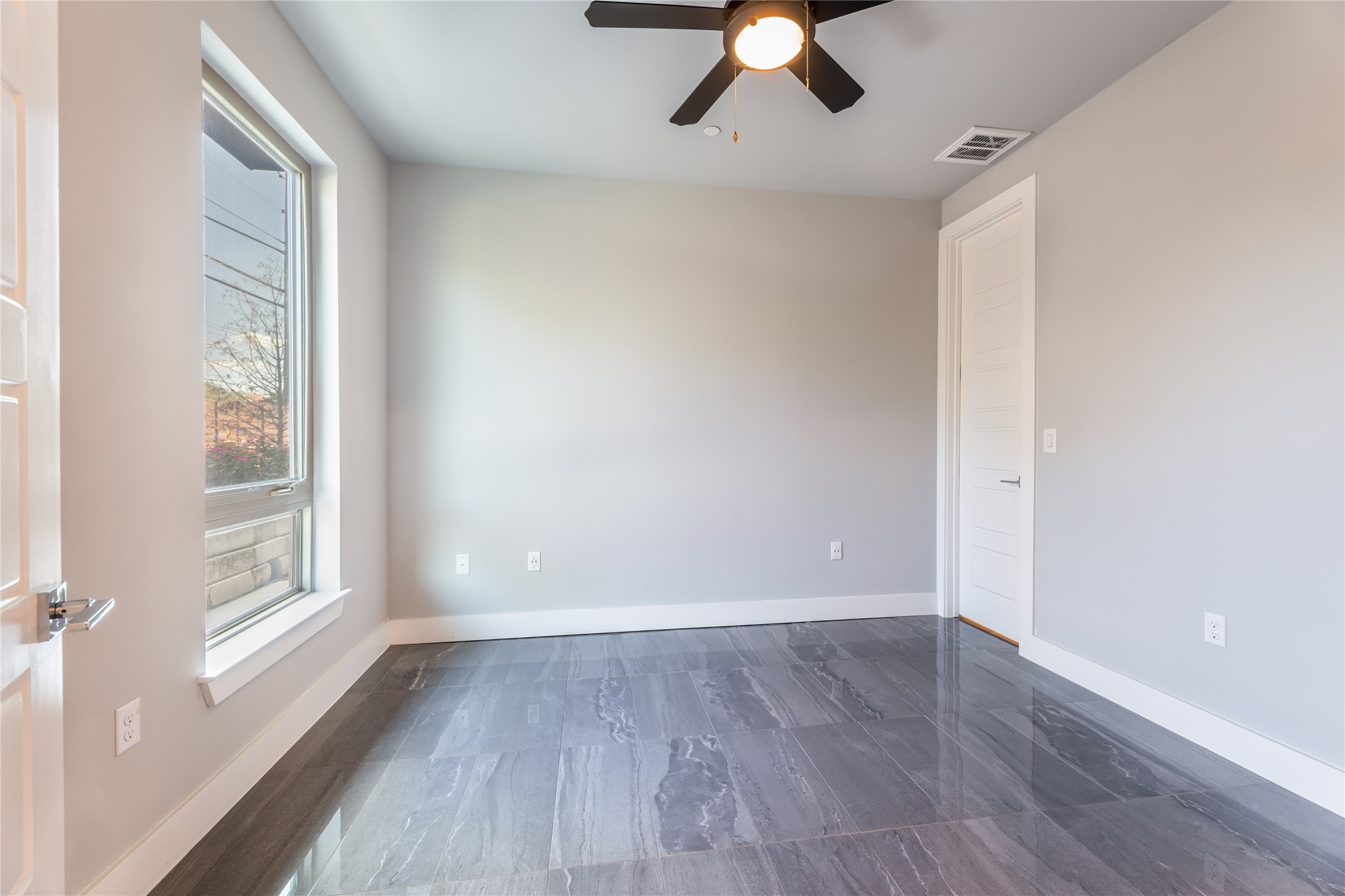 1417 Kramer Lane, Unit 9 Austin, TX 78758 - Photo 11 of 40 Spare room featuring a ceiling fan and dark marble finish floors