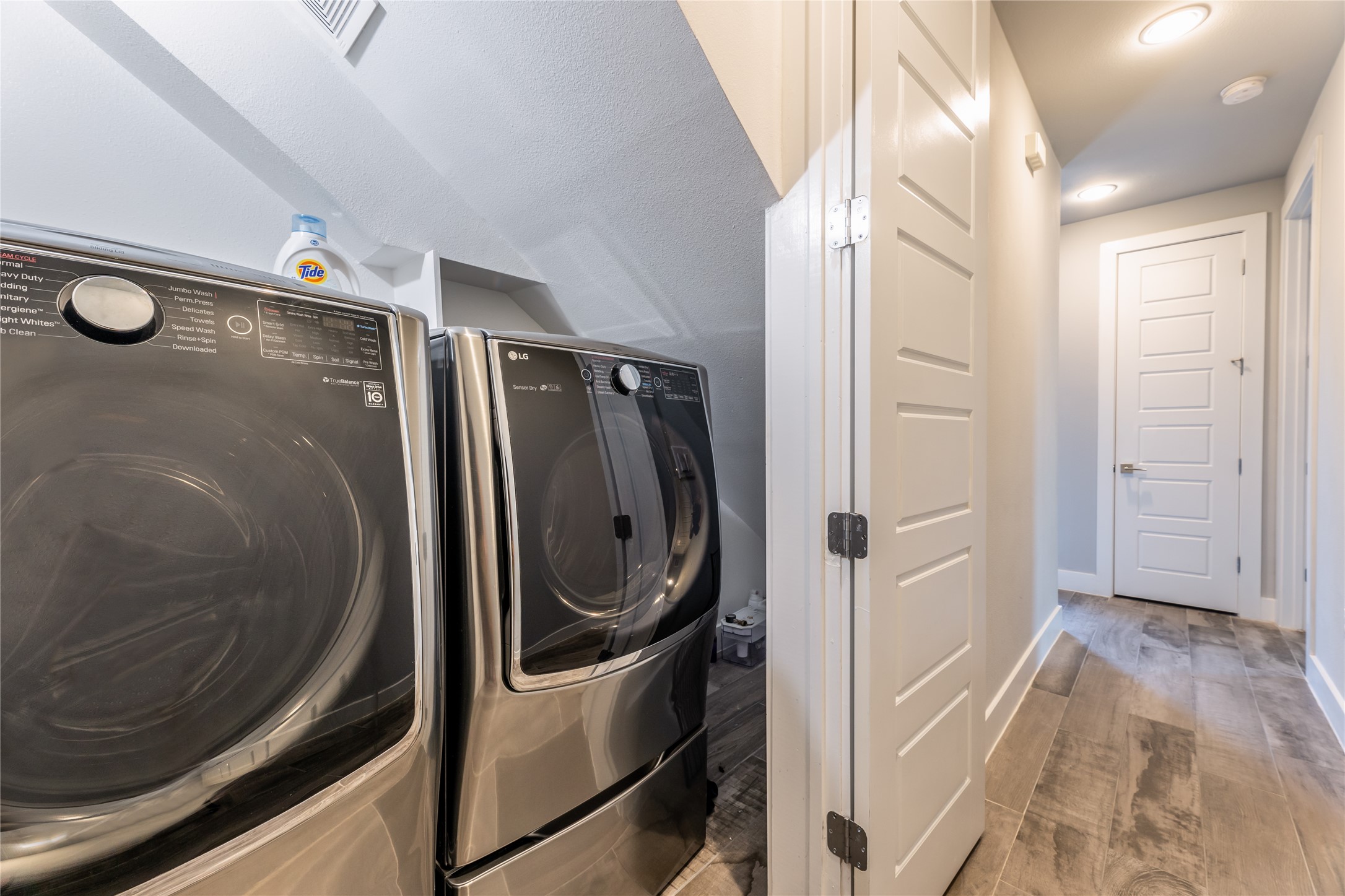 1417 Kramer Lane, Unit 9 Austin, TX 78758 - Photo 14 of 40 Laundry area featuring light wood finished floors and washing machine and clothes dryer