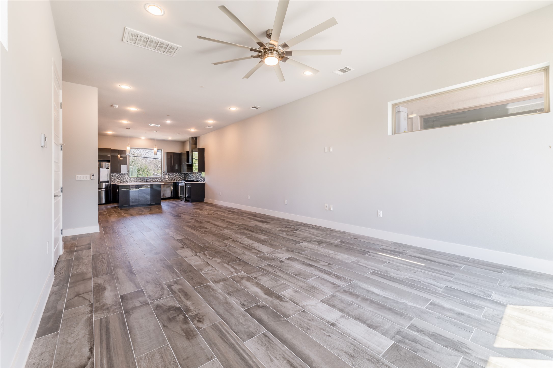 1417 Kramer Lane, Unit 9 Austin, TX 78758 - Photo 17 of 40 Unfurnished living room with recessed lighting, wood tiled floors, and a ceiling fan