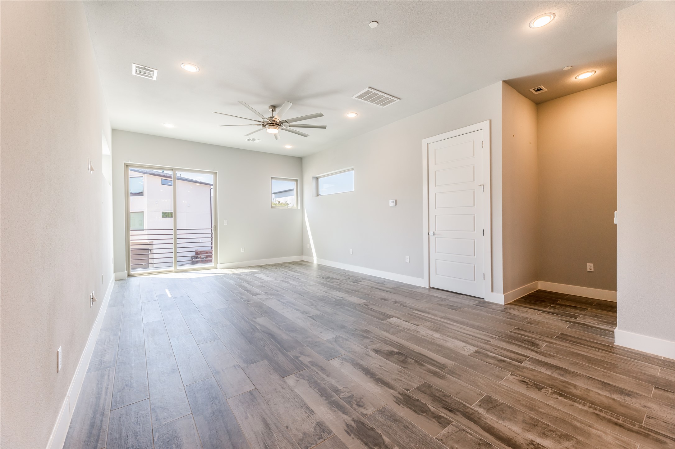 1417 Kramer Lane, Unit 9 Austin, TX 78758 - Photo 18 of 40 Unfurnished room featuring a ceiling fan, wood finished floors, and recessed lighting
