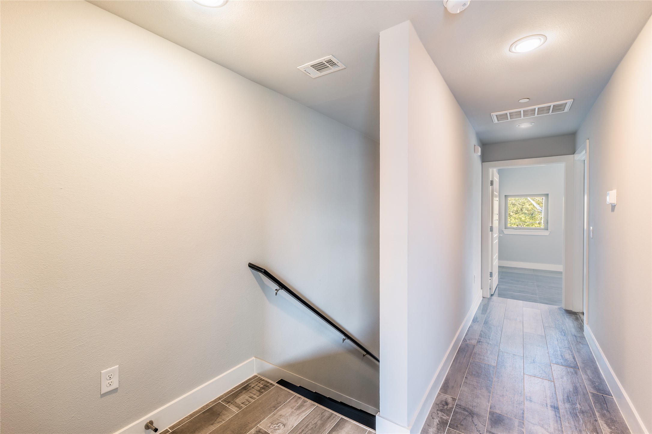 1417 Kramer Lane, Unit 9 Austin, TX 78758 - Photo 34 of 40 Corridor with an upstairs landing, wood finish floors, and recessed lighting