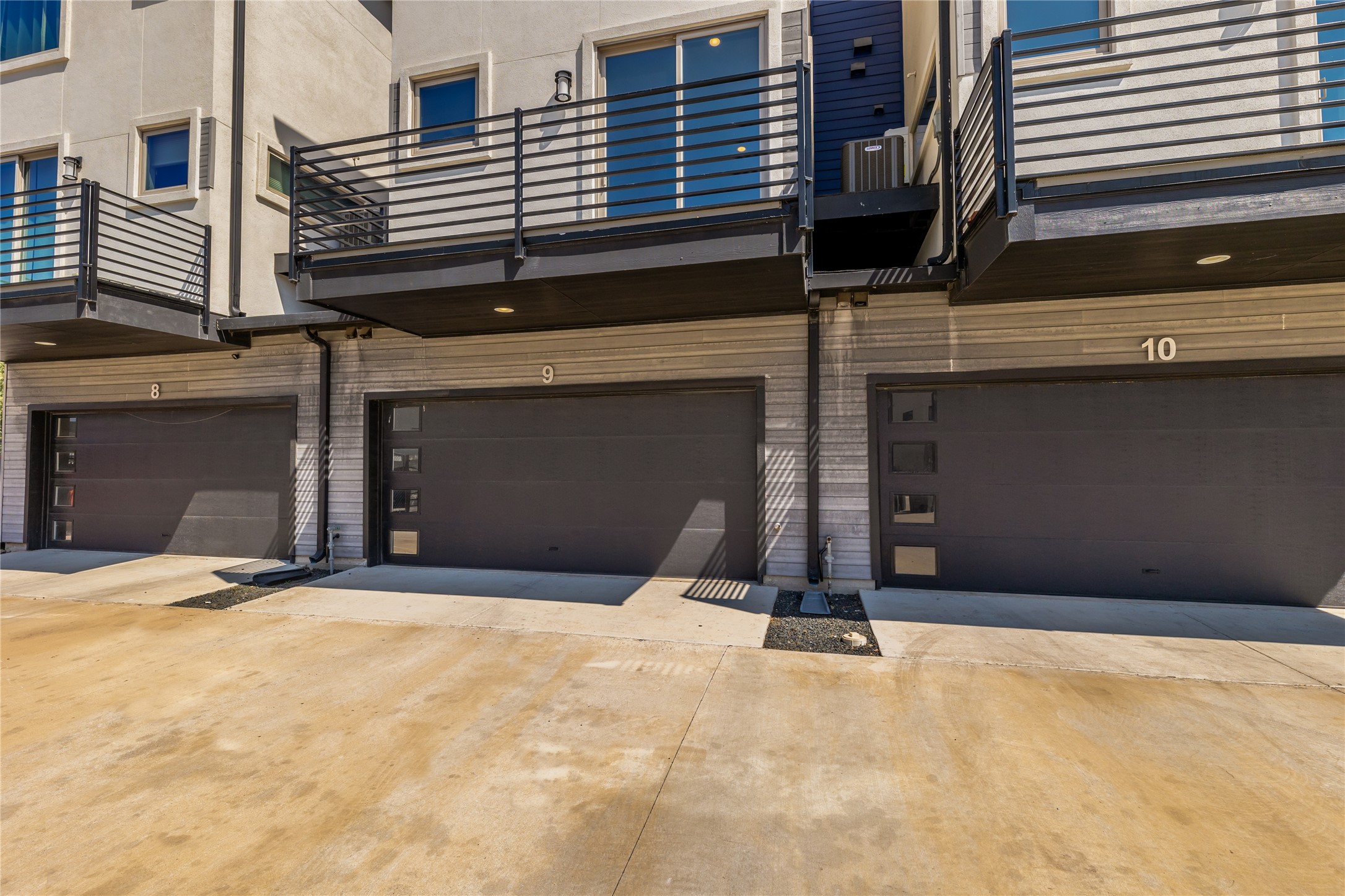 1417 Kramer Lane, Unit 9 Austin, TX 78758 - Photo 4 of 40 Garage featuring concrete driveway