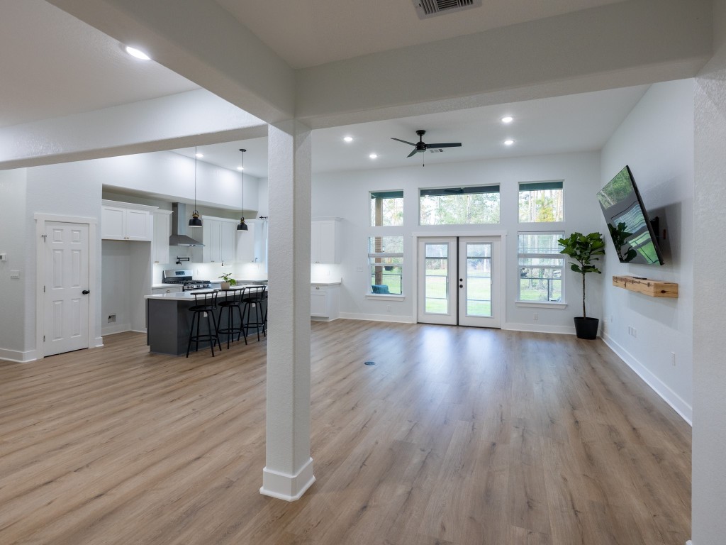 111 V Allen Lane Coldspring, TX 77331 - Photo 2 of 35 a view of a kitchen with kitchen island wooden floors appliances and a window