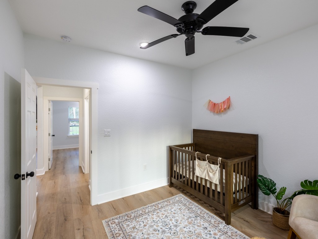 111 V Allen Lane Coldspring, TX 77331 - Photo 22 of 35 a bedroom with furniture and wooden floor