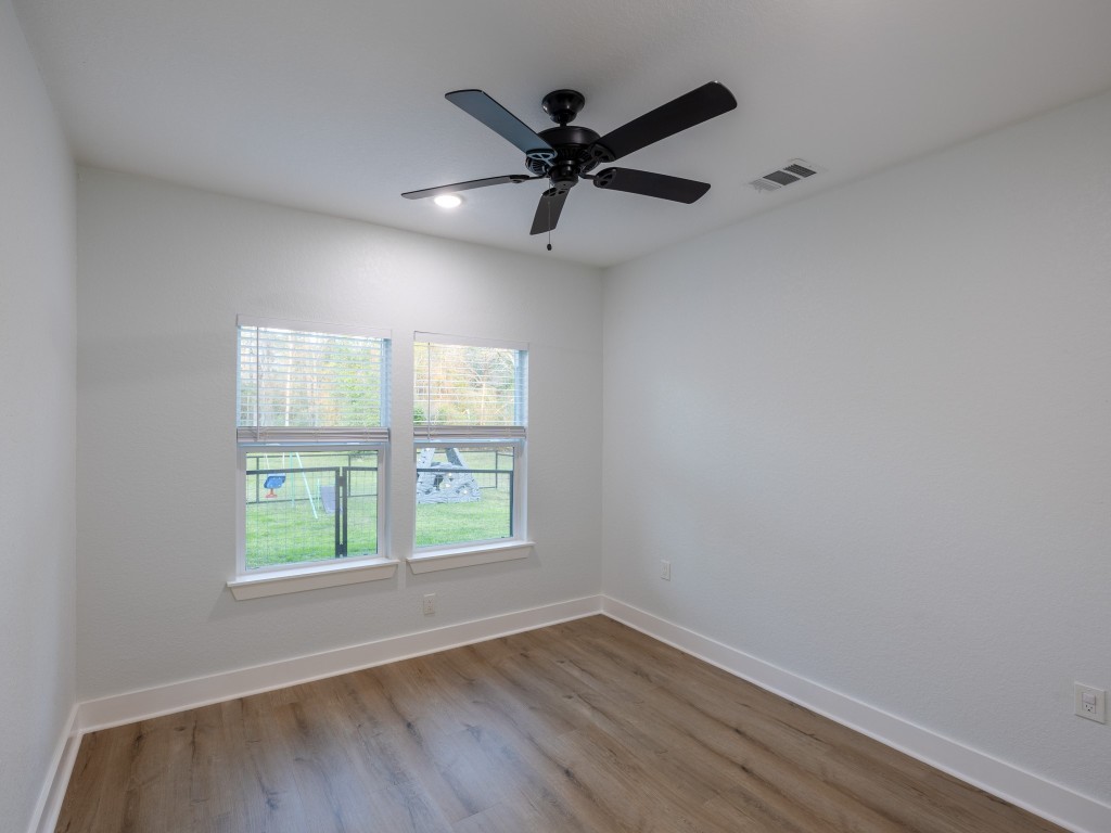 111 V Allen Lane Coldspring, TX 77331 - Photo 26 of 35 an empty room with wooden floor and windows
