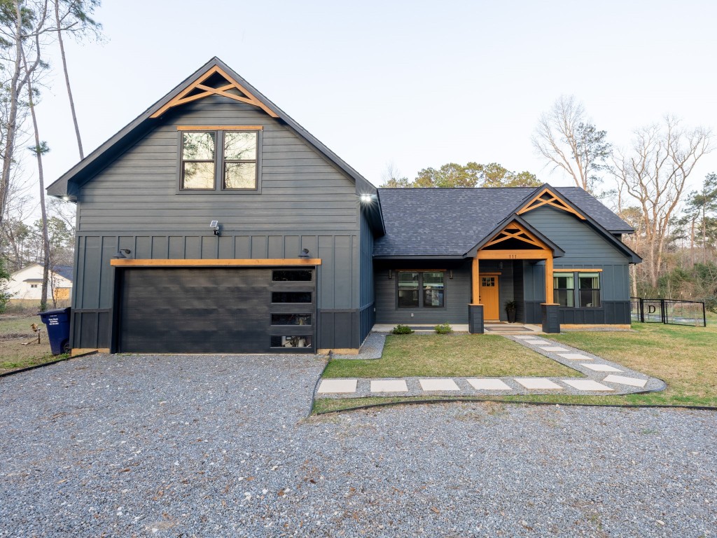 111 V Allen Lane Coldspring, TX 77331 - Photo 30 of 35 a front view of a house with a yard and garage