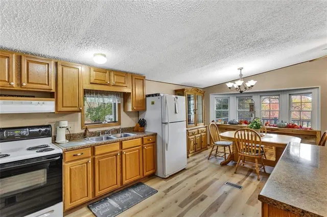 a kitchen with sink cabinets and wooden floor