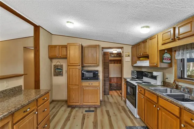 a kitchen with stainless steel appliances a refrigerator stove and sink