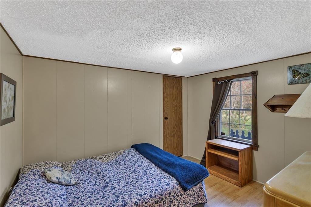 2200 Prospect Road Prospect, PA 16052 - Photo 17 of 47 a bedroom with a bed and wooden floor