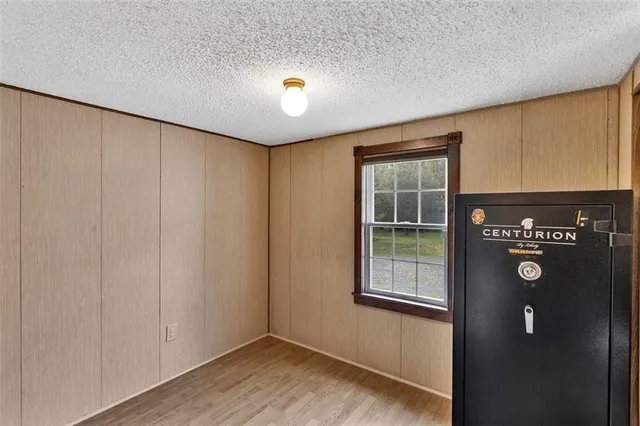 a view of an empty room with window and stairs