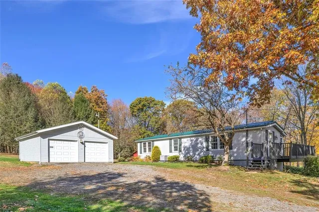 a front view of house with yard and green space