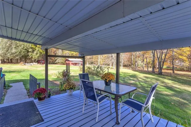 a view of a patio with a table chairs and a backyard
