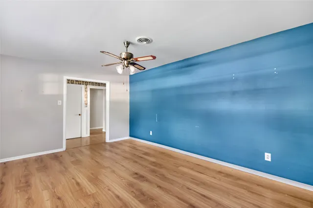 a view of a livingroom with a ceiling fan and window