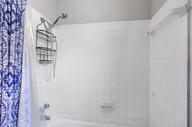 a view of a big room with a ceiling fan and closet area