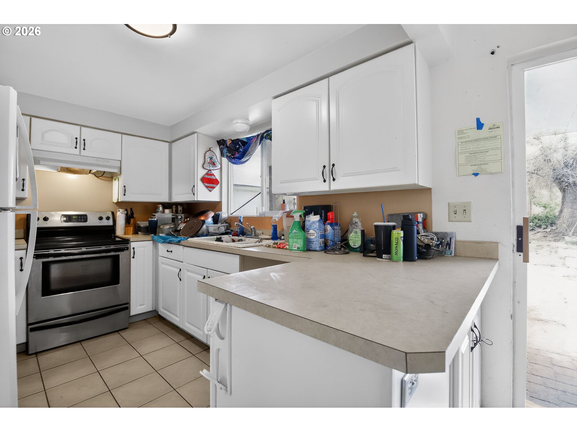 376 Northeast Chestnut Street Madras, OR 97741 - Photo 11 of 26 a kitchen with a sink a stove and cabinets