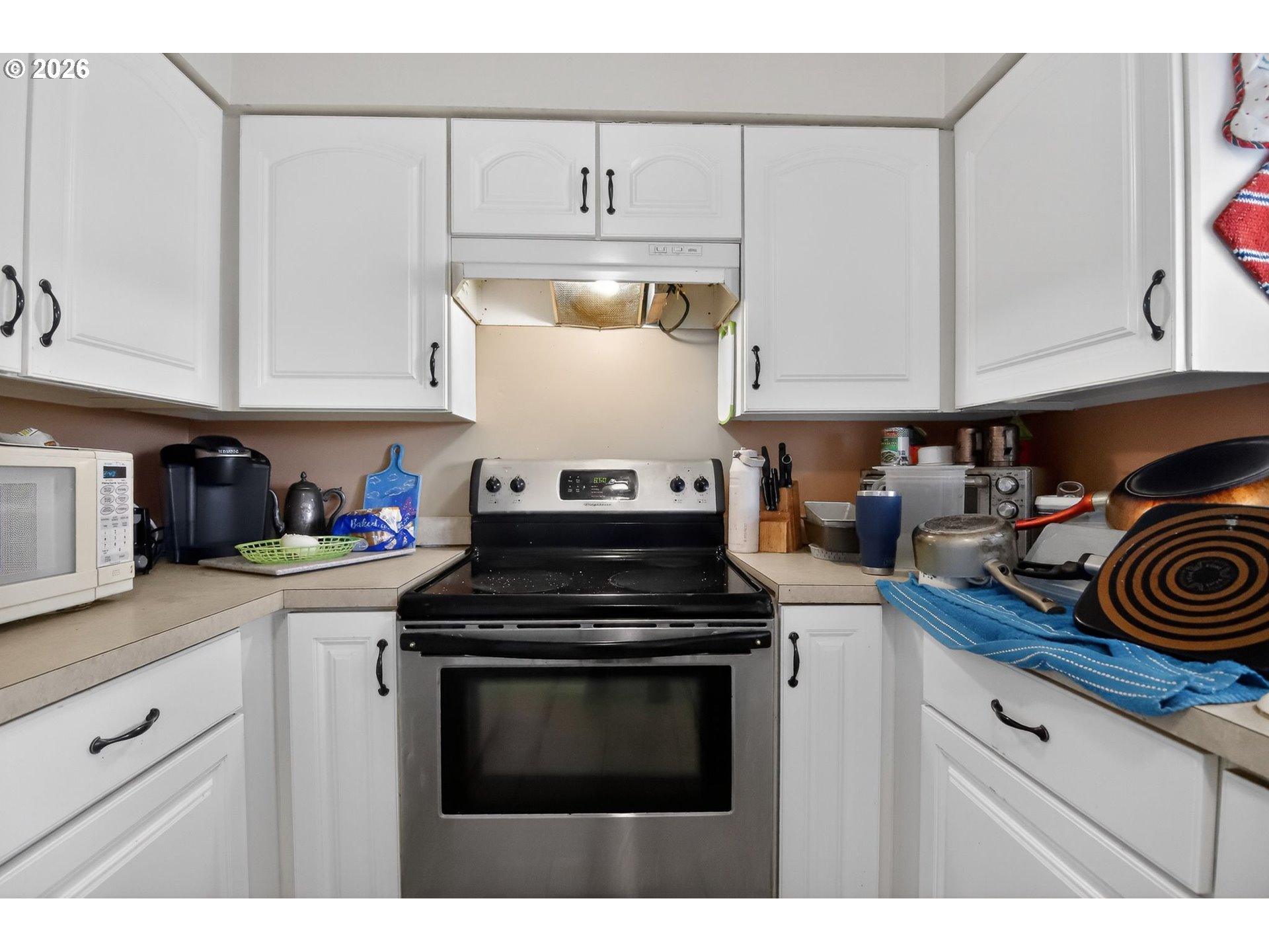 376 Northeast Chestnut Street Madras, OR 97741 - Photo 13 of 26 a kitchen with cabinets and stainless steel appliances