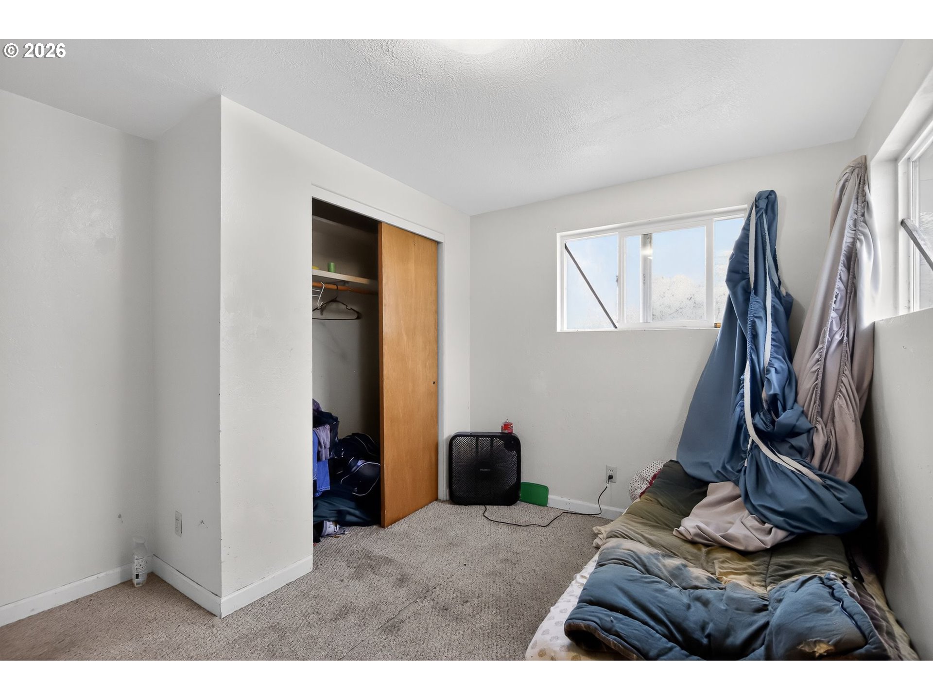 376 Northeast Chestnut Street Madras, OR 97741 - Photo 16 of 26 a bed room with a bed and a window