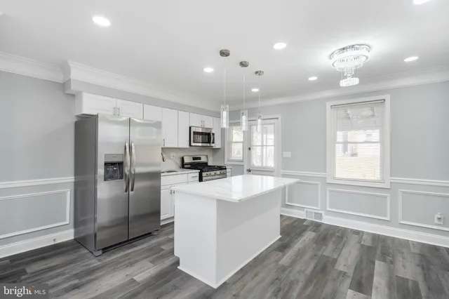 a kitchen with refrigerator and windows