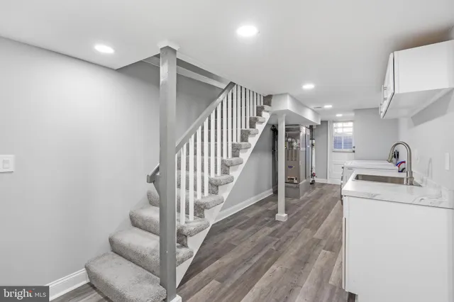 a kitchen with sink cabinets and wooden floor