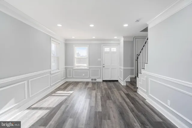 a view of an empty room with wooden floor