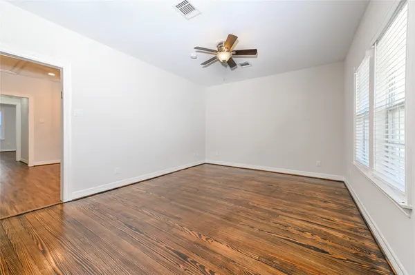 wooden floor in an empty room with a window