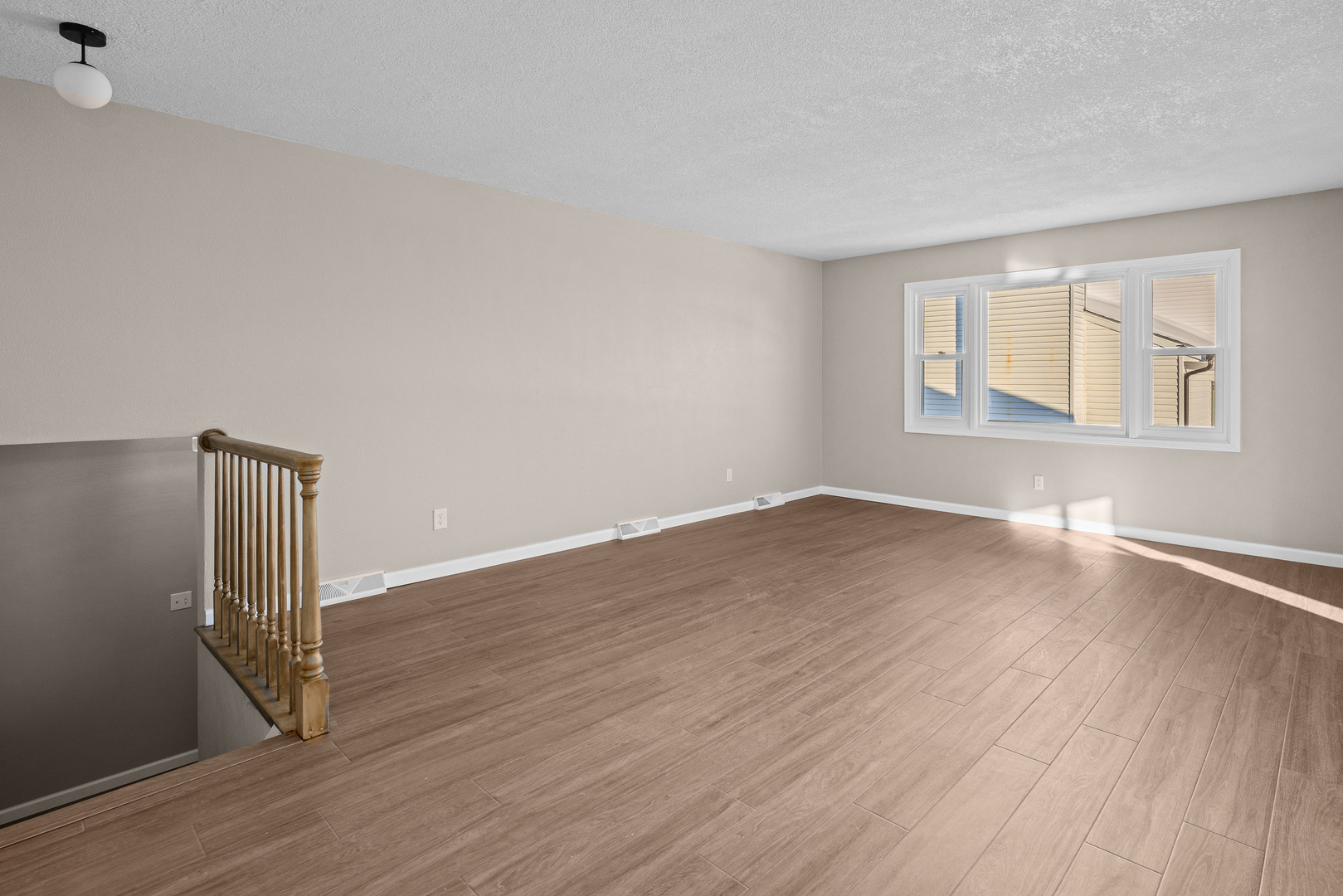 5302 16th Avenue Moline, IL 61265 - Photo 3 of 34 an empty room with wooden floor and windows